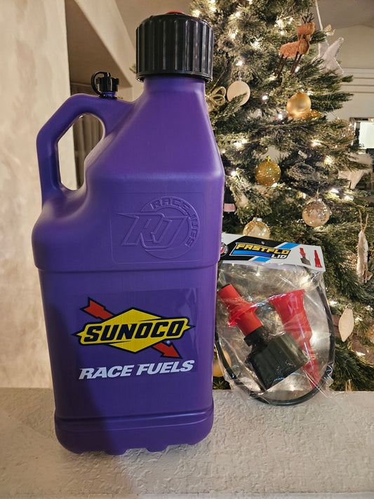 Purple Sunoco race fuels container on a surface with a Christmas tree in the background